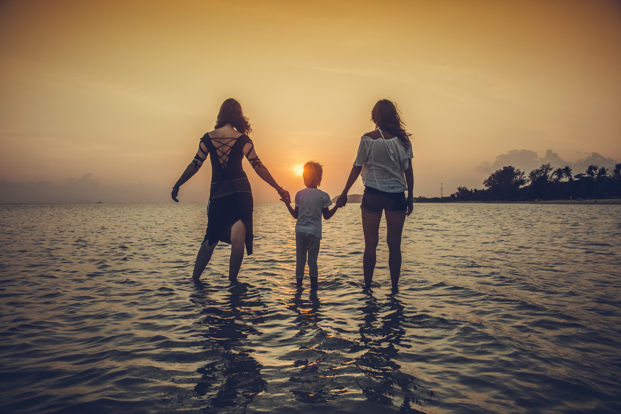 family is running on the tropical beach